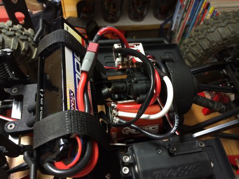 1989 Ford Bronco - Close-up of the electronic components and battery pack of a remote-controlled car.