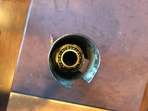 1965 Ford Mustang - Close-up of a ball bearing assembly within a metal casing, likely a vehicle component.
