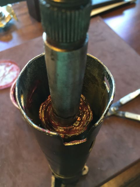 1965 Ford Mustang - Steering column part being greased, showing internal splines and metal housing.