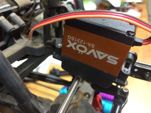 1989 Ford Bronco - Close-up of a SAVOX SA-1231SG servo motor, part of an RC vehicle's steering mechanism.