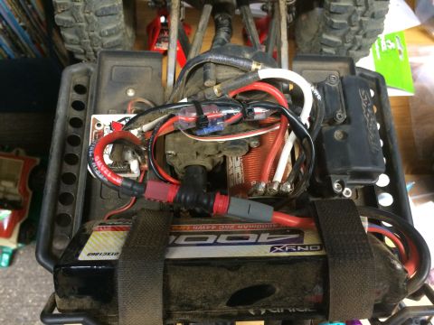 1989 Ford Bronco - Close-up view of the internal electronics and battery of a remote control car.