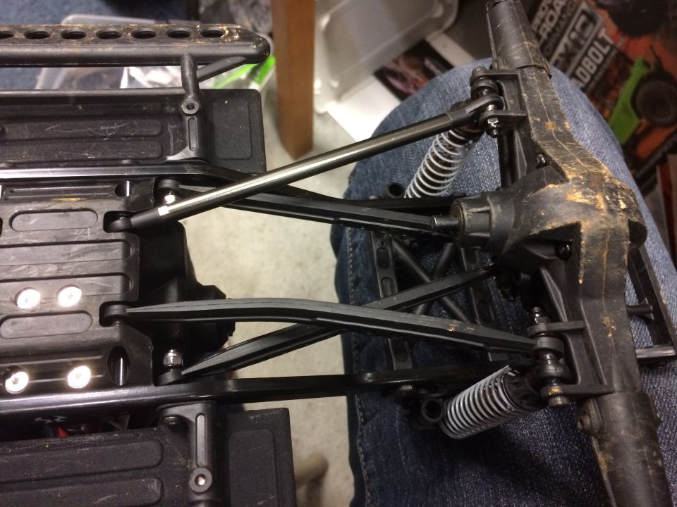 Black remote control car chassis with suspension components and metal linkages