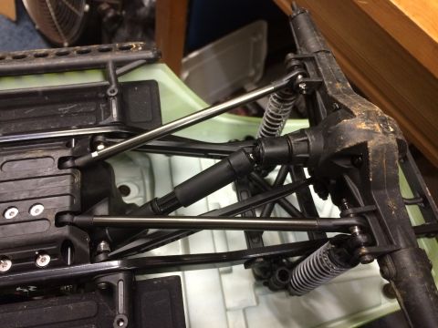 1989 Ford Bronco - Close-up view of the suspension and drivetrain of a remote-controlled vehicle chassis.