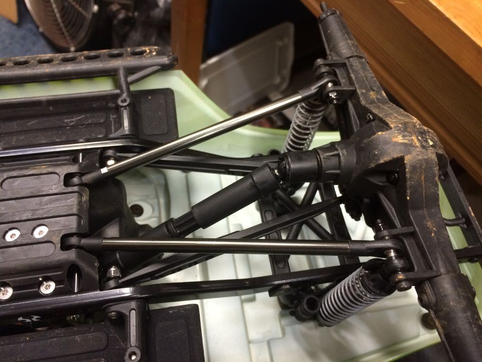 Underside of RC car chassis showing suspension and drivetrain components