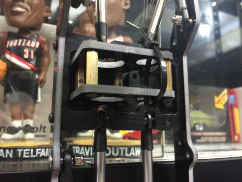 1989 Ford Bronco - A detailed view of a mechanical assembly, with a blurred background of collectible figures and a toy car.