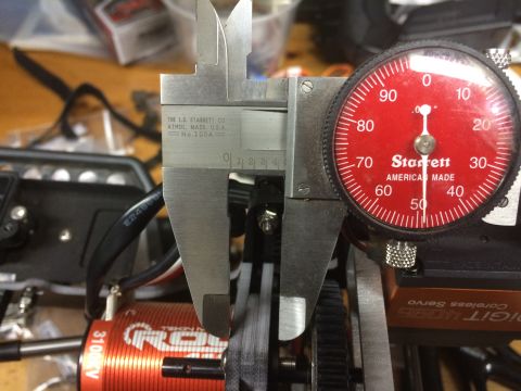 1989 Ford Bronco - A dial caliper is used to measure a component, with a Starrett gauge indicating the measurement.
