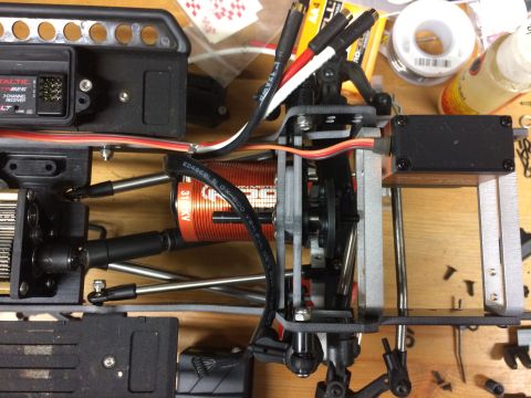 1989 Ford Bronco - Close-up view of an RC car's internal components, including the motor, receiver, and suspension linkages.