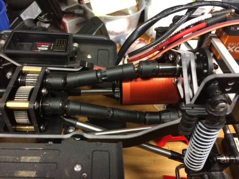 1989 Ford Bronco - Close-up of an RC car's internal components, including the motor, gears, and electronics.