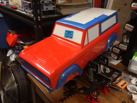 1989 Ford Bronco - This RC car body, possibly a Bronco, is partially assembled and sits on a workbench with various hobby supplies.