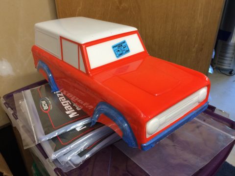 1989 Ford Bronco - A toy Bronco, possibly a promotional item, sits on top of magazine protectors.