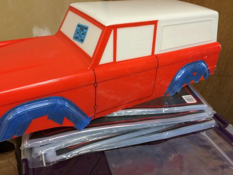 1989 Ford Bronco - Plastic model car body, possibly for a Bronco, with protective film on the windshield.