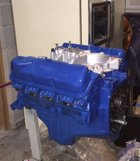 1978 Ford Bronco - A blue painted Ford V8 engine is mounted on a white engine stand. The engine features a silver intake manifold and blue valve covers with v…