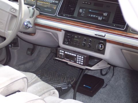 2001 Ford Crown Victoria - Car interior with aftermarket radio and Motorola scanner. Year estimated based on dashboard design.
