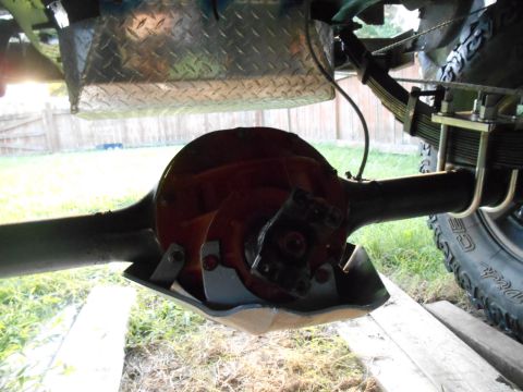 1972 Ford Bronco - Close-up view of a vehicle's rear differential and leaf spring suspension system.