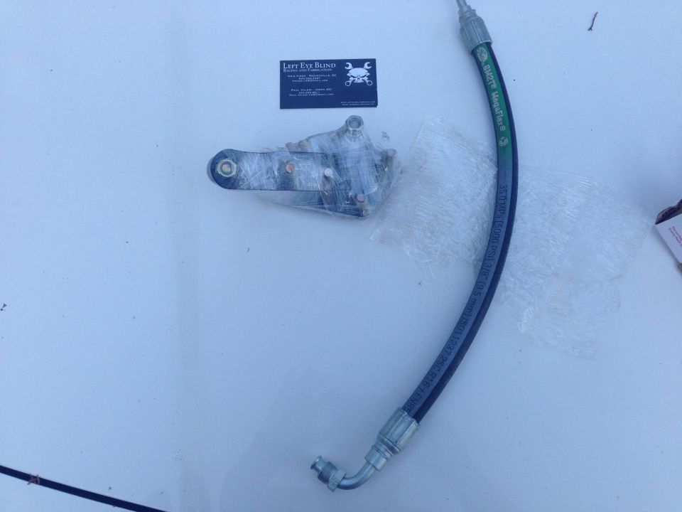 Power steering hose and bracket assembly