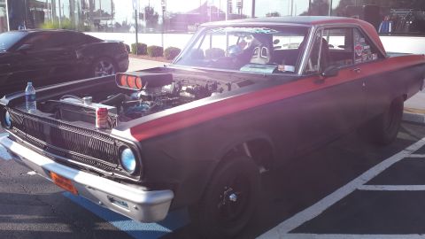1976 Ford Ranchero - This customized muscle car features an open hood revealing its engine and a racing seat inside.