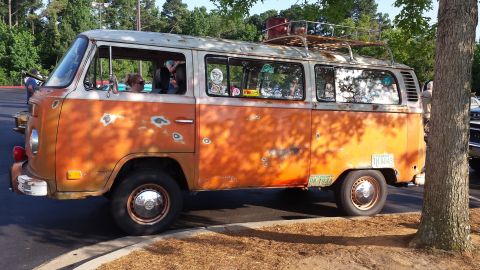 1976 Ford Ranchero - This vintage Volkswagen bus has a weathered exterior and is parked outdoors.
