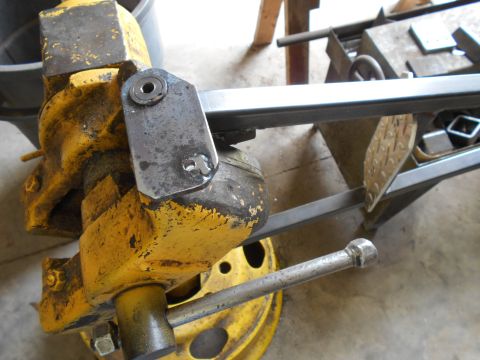 1992 Ford Bronco - A yellow vise is used to hold a metal part in place for fabrication or repair.