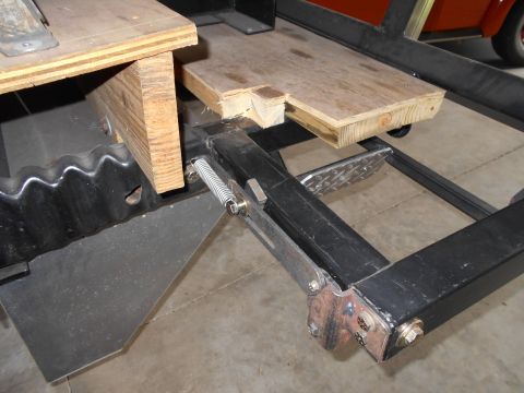 1992 Ford Bronco - Close-up view of a vehicle's frame, showing wooden supports and mechanical components.