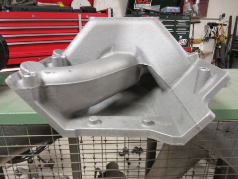 Aluminum intake manifold with a hexagonal base and a curved intake runner