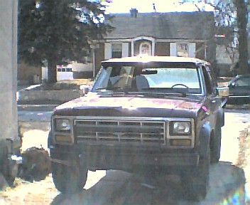 1985 Ford Bronco - Front view of a red 1983-1988 Ford Ranger pickup truck. The Supermotors.net logo is visible in the lower right corner.