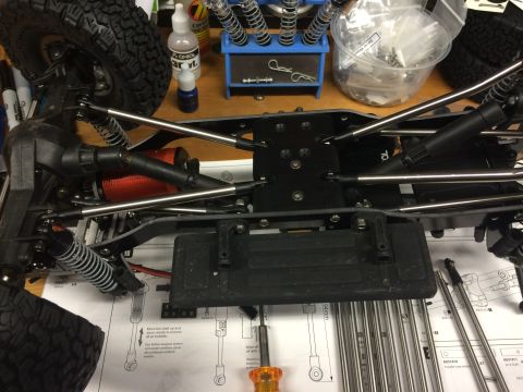 1989 Ford Bronco - Close-up of an RC car chassis, showing suspension components, motor, and assembly diagrams.