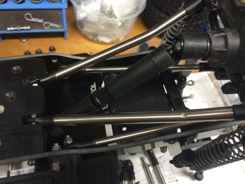 1989 Ford Bronco - RC car suspension components, including shocks and metal linkages, are visible.