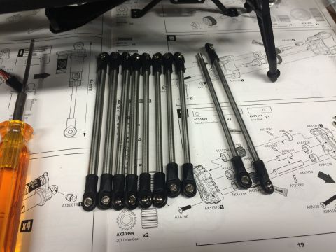 1989 Ford Bronco - RC car parts and assembly instructions are spread out on a table, ready for building.