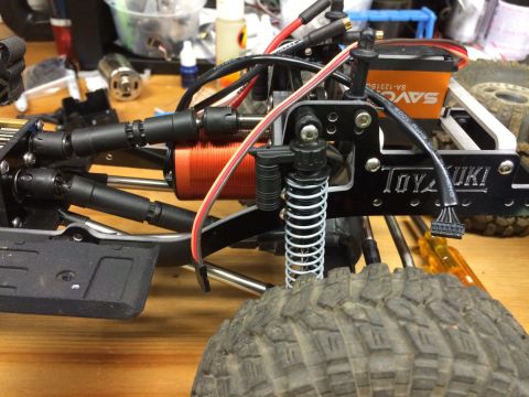 1989 Ford Bronco - Close-up view of an RC car's chassis components, including the motor and suspension.