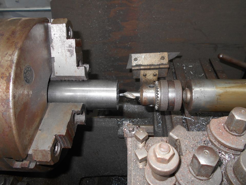 metal rod being drilled on a lathe