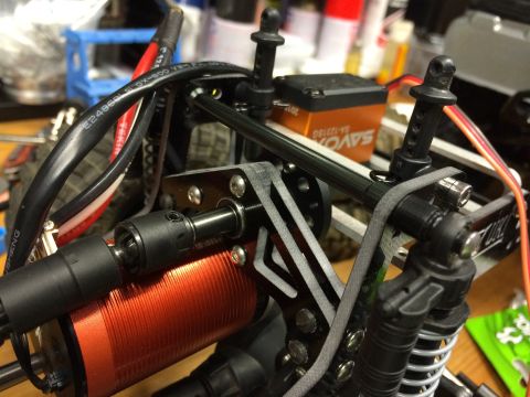 1989 Ford Bronco - Close-up view of an RC car's internal components, an orange motor and suspension system.