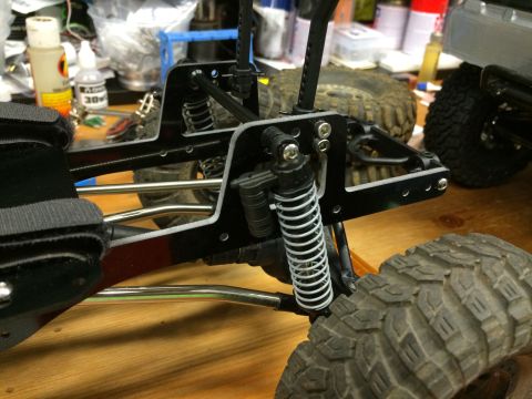 1989 Ford Bronco - Close-up of a remote-controlled car's suspension system and a large tire.