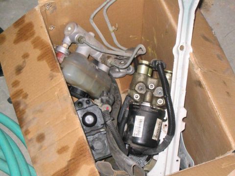1996 Ford Bronco - Several automotive brake system components are stored inside a cardboard box.