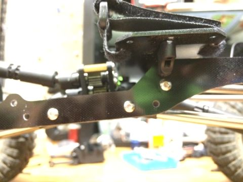 1989 Ford Bronco - Close-up view of a remote control car's chassis, showing suspension and camouflage detailing.
