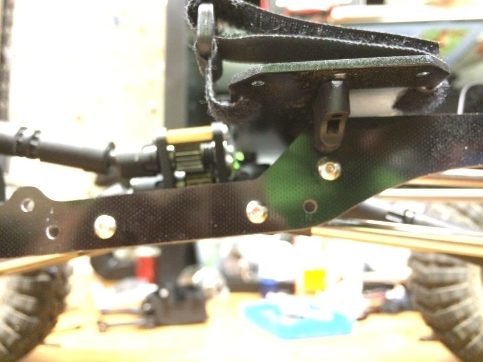 RC car chassis with suspension components and camouflage pattern