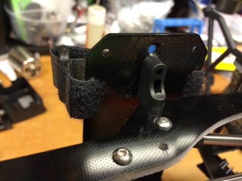 1989 Ford Bronco - Detail of a component, possibly from an RC car, showing screws and velcro straps.
