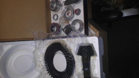 1991 Ford Bronco - A set of differential gears and bearings are laid out in their packaging.