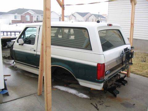 1996 Ford Bronco - This 1996 Ford Bronco is partially disassembled and supported by wooden beams, indicating it is in a state of repair.
