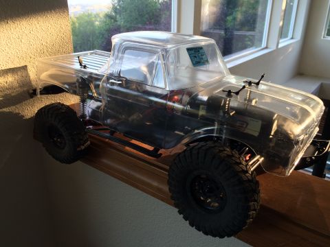 1989 Ford Bronco - This is a clear, unpainted RC truck body with visible internal components and large off-road tires.