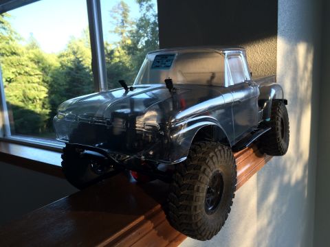 1989 Ford Bronco - This clear plastic RC truck body, likely a model of an older pickup, is displayed on a wooden surface with a natural background.