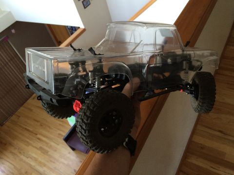 1989 Ford Bronco - RC truck body held in hand, showing off its clear plastic shell and off-road tires.