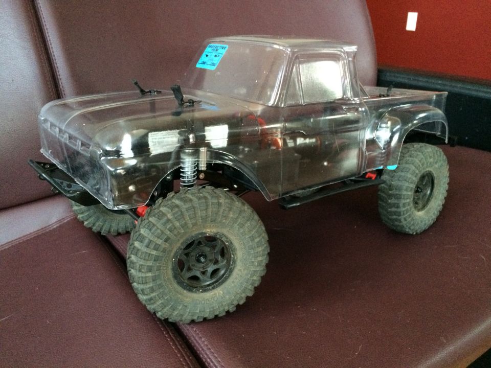 Clear RC truck body with large tires, side view