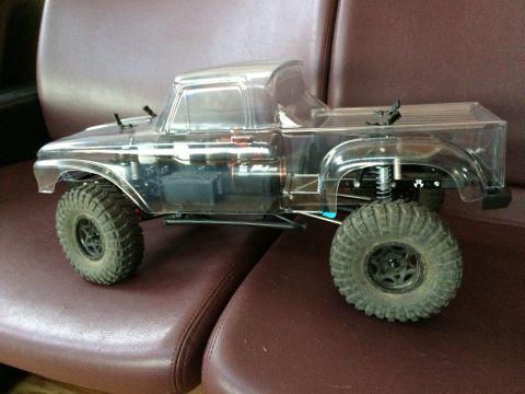 1989 Ford Bronco - RC rock crawler truck with clear body and large tires.