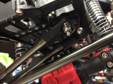 1989 Ford Bronco - Close-up of RC car suspension components and a red Axial gearbox.