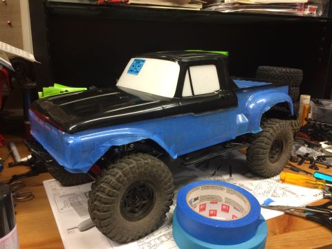1989 Ford Bronco - RC truck body, possibly a Ford F-100, is partially taped and ready for paint.