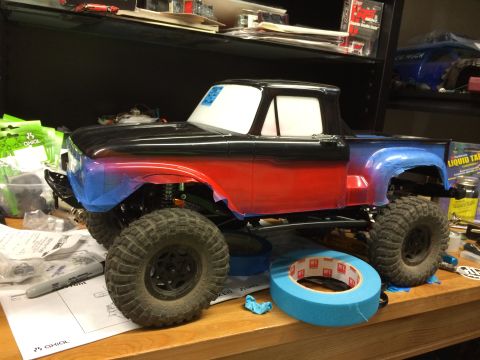 1989 Ford Bronco - RC truck body undergoing paint customization, a gradient from red to blue on the lower half and a black roof.