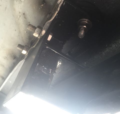 1995 Ford Bronco - Underside view of vehicle frame components and fasteners.