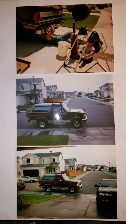 1996 Ford Bronco - A maroon 1996 Ford Bronco is parked on a wet suburban street, with a house and other vehicles visible in the background.
