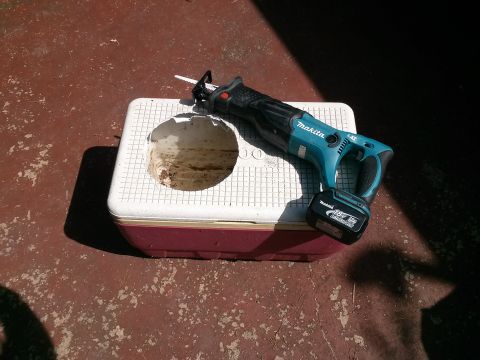 1996 Ford Bronco - Makita reciprocating saw and a cooler with a hole cut into it.
