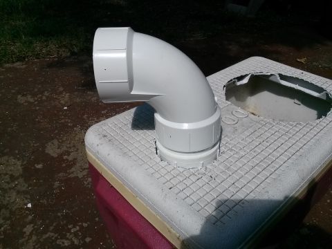 1996 Ford Bronco - A white PVC pipe elbow is attached to a cooler, likely for ventilation or drainage purposes.